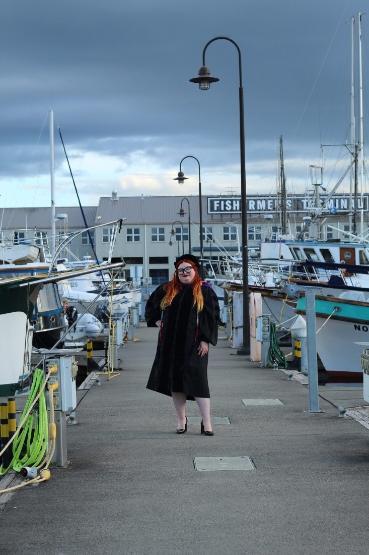 Makayla Gustafson in cap and gown at Fisherman's Terminal.